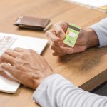 A man with laptop and visa credit card paying for digital services